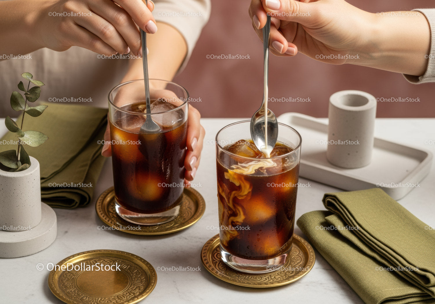 Refreshing Iced Cola with Silver Spoons and Gold Coasters