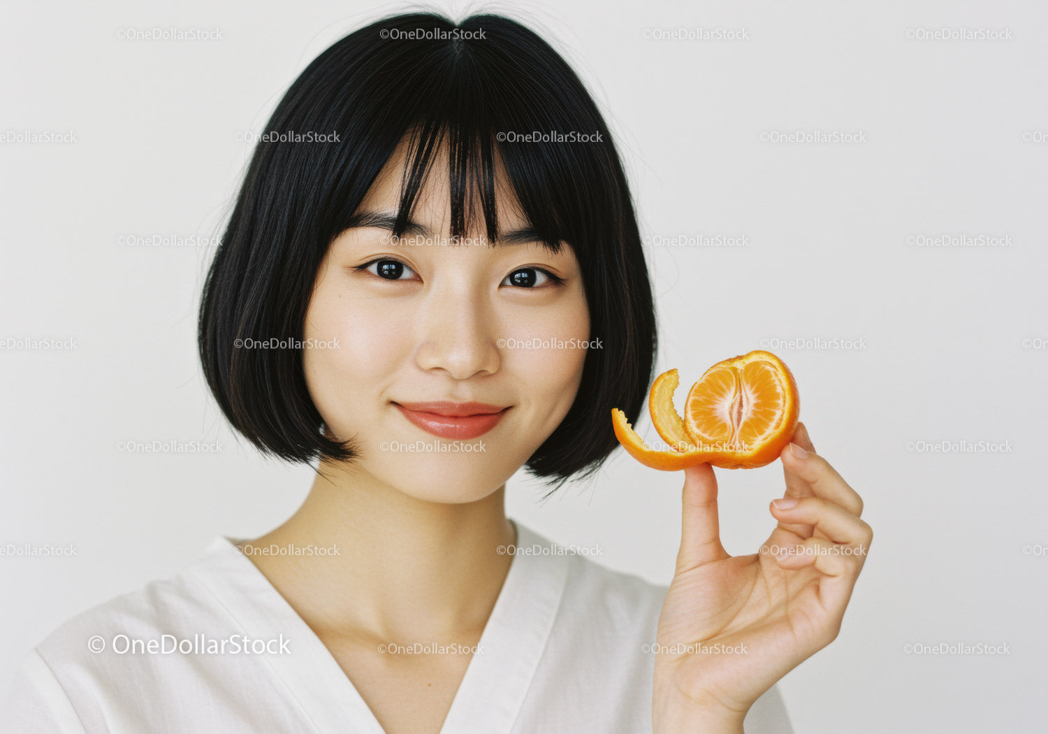 Young Woman Holding Fresh Orange Citrus Fruit in Bright Background