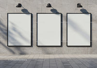 Three blank vertical posters on modern concrete wall