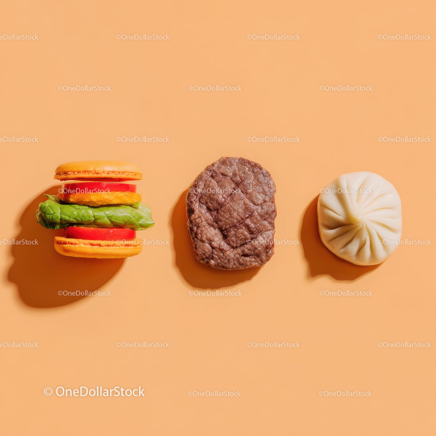 Gourmet Burger with Lettuce and Tomato Next to Grilled Steak and Dumpling