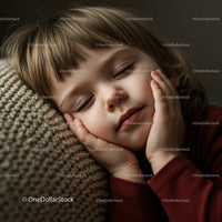 Peaceful child resting with eyes closed on knitted cushion