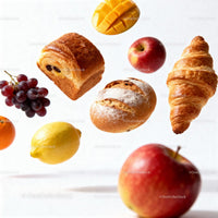 Assorted fresh fruits and bakery items floating on white