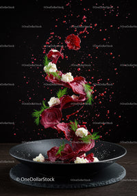 Fresh beetroot chips with cheese and dill on black plate