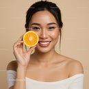 Vibrant Cheerful Woman Holding Fresh Orange Slice for Healthy Lifestyle