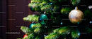 Green and Gold Christmas Ornaments on Pine Tree