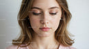 Elegant Young Woman with Natural Makeup in Soft Lighting