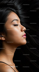 Serene profile of young woman with flowing black hair
