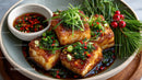 Crispy Tofu with Spicy Soy Sauce Garnished with Fresh Herbs and Vegetables