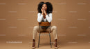 Thoughtful Woman Seated in Elegant Attire Against Brown Background