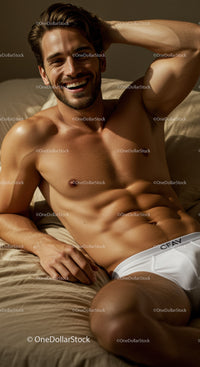 Smiling man relaxing shirtless in white briefs on bed