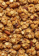 Crunchy oat granola clusters with roasted almonds closeup