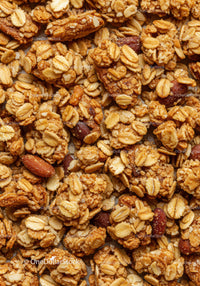 Crunchy oat granola clusters with roasted almonds closeup