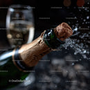 Champagne Bottle with Popping Cork and Bubbles in Dark Setting