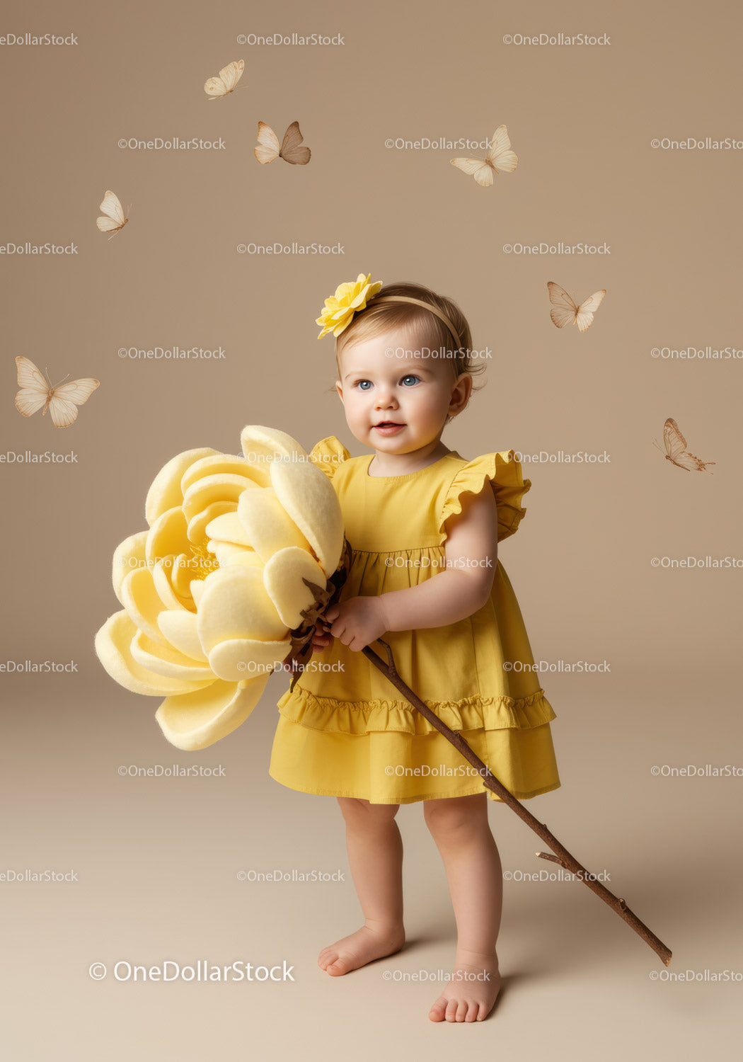 Toddler girl in yellow dress holding huge flower
