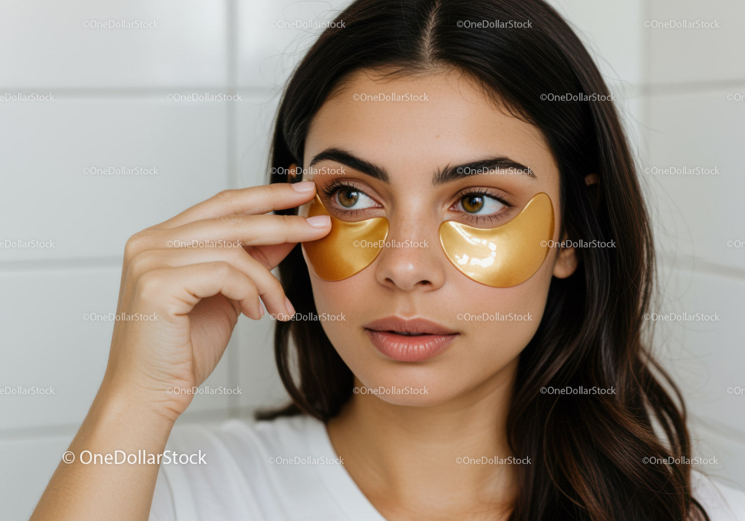 Young Woman Applying Under Eye Gold Gel Patches for Skin Care