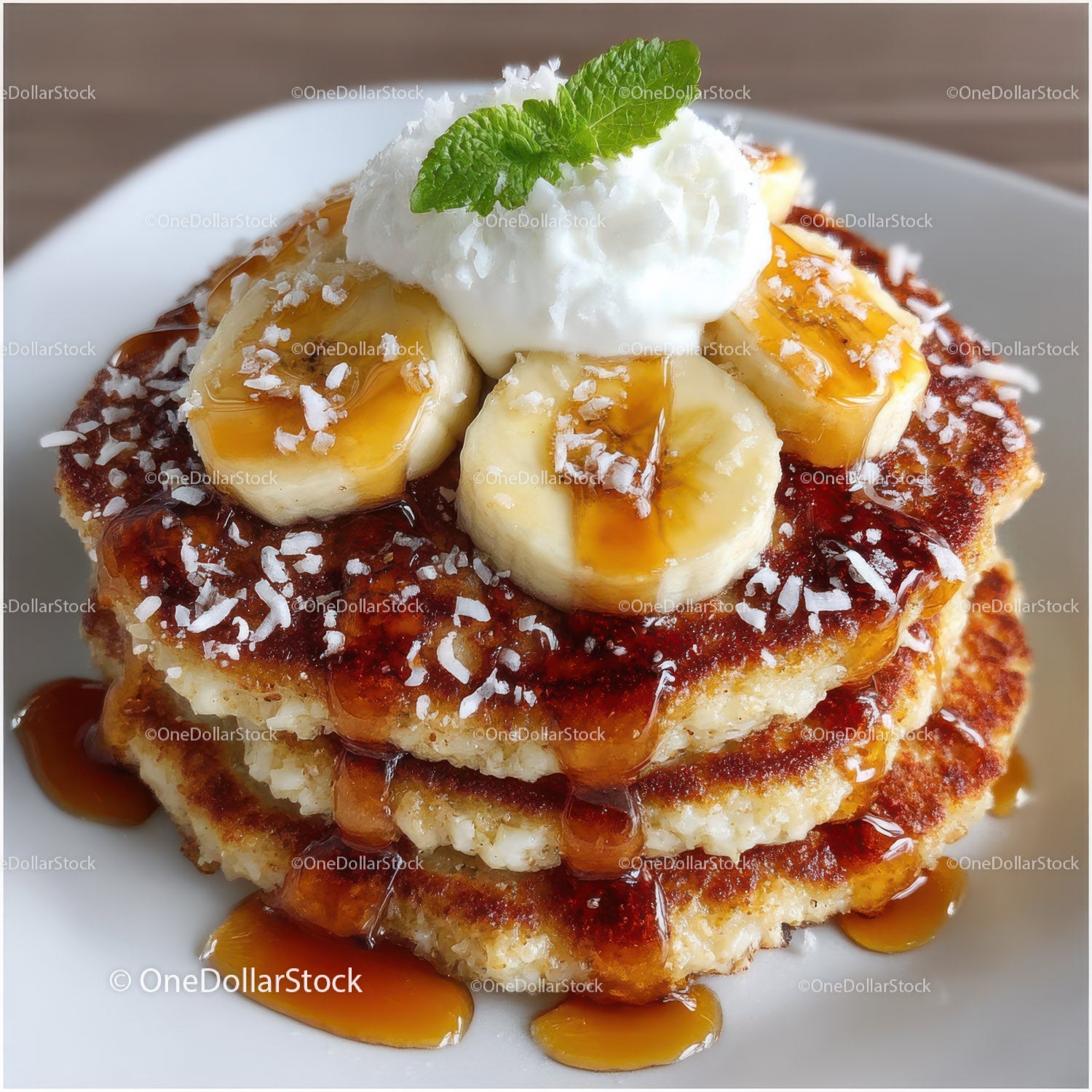 Banana and Caramel Stack with Whipped Cream and Mint Leaf