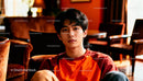 Young man relaxing in cozy warm-toned lounge