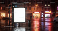 Night City Street Scene with Illuminated Bus Shelter and Rain Reflections