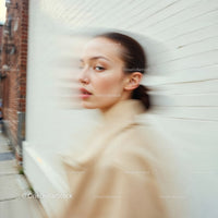 Stylish Woman in Motion Wearing Elegant Beige Outfit