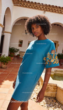 Elegant Woman in Blue Dress with Floral Embroidery
