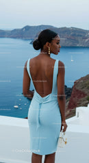 Elegant woman in blue dress overlooking ocean view