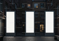Three Large Illuminated Blank Billboards in Urban Alley