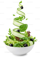 Fresh green salad with cucumber ribbons and black olives