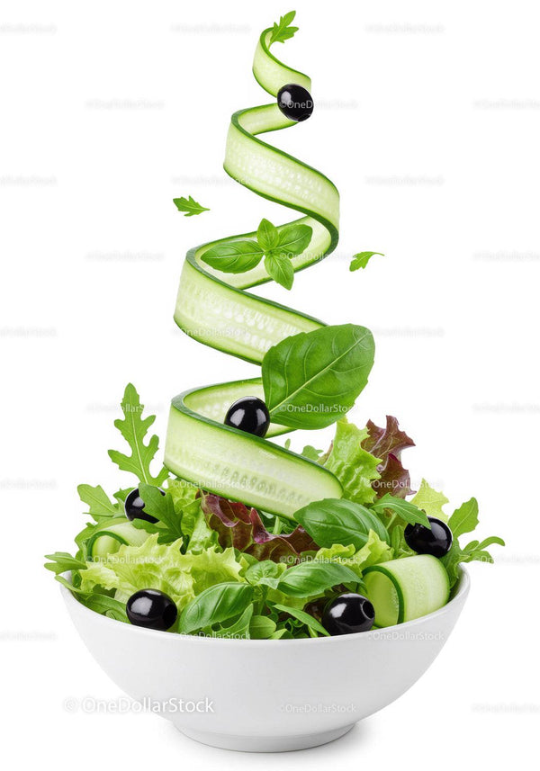 Fresh green salad with cucumber ribbons and black olives