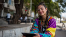 Bright Young Woman Wearing Colorful Jacket Smiling Outdoors