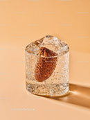 Refreshing close-up of soda with ice cube and bread