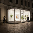 Night view of modern illuminated urban storefront with greenery