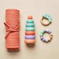 Minimalist baby toys and swaddle blanket arrangement