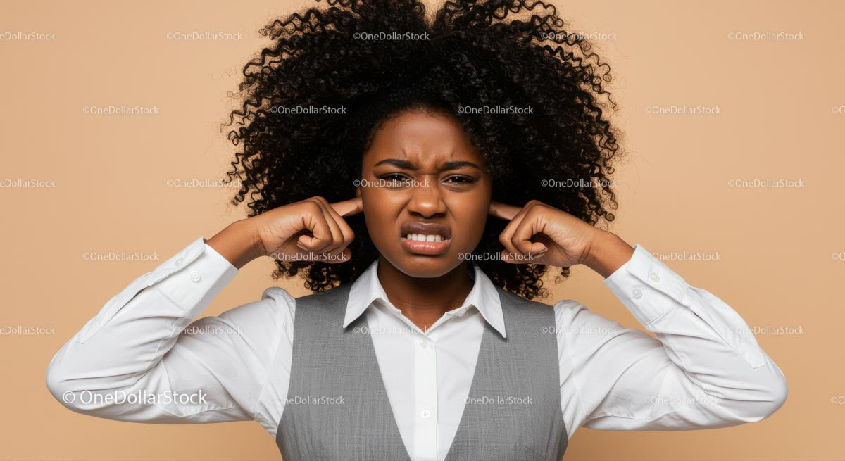 Frustrated Woman Covering Ears with Annoyed Expression