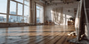 Bright Sunlit Spacious Room with Wooden Floor and Large Windows