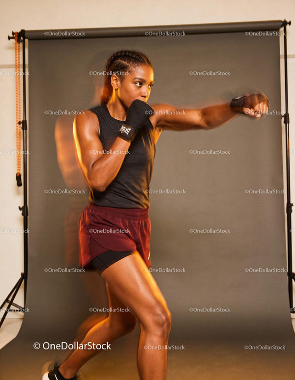 Female athlete practicing boxing punches indoors