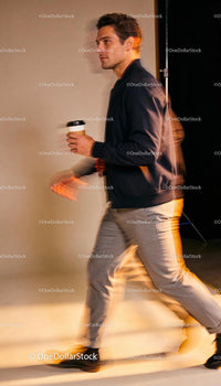Stylish man walking confidently with coffee cup