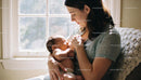 Mother Breastfeeding Newborn in Peaceful Sunlit Room