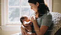 Mother Breastfeeding Newborn in Peaceful Sunlit Room