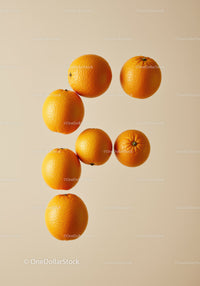 Fresh whole oranges floating on beige background
