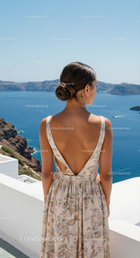 Woman enjoying scenic ocean view in summer dress