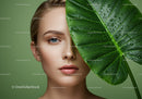 Close-up of Beautiful Woman with Tropical Leaf and Dew Drops