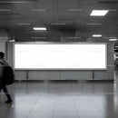 Empty illuminated billboard in modern indoor public space