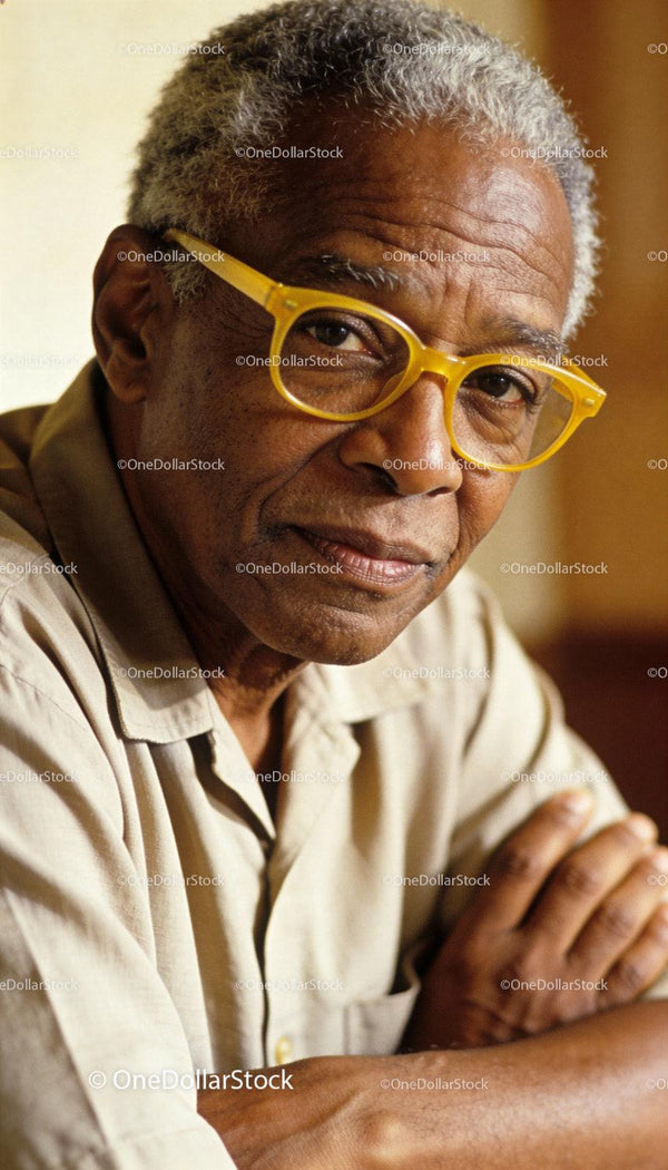 Elderly man with yellow glasses in warm light