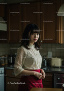 Elegant Woman in Lace Blouse and Red Skirt in Stylish Kitchen