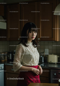 Elegant Woman in Lace Blouse and Red Skirt in Stylish Kitchen