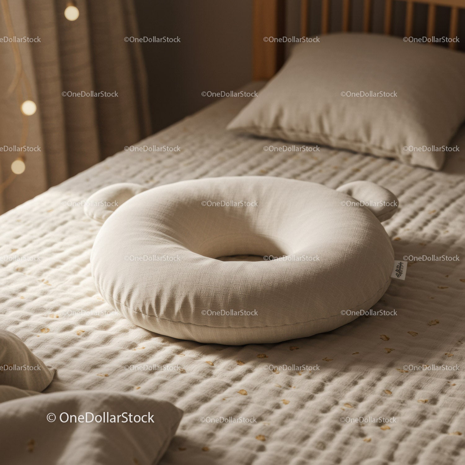Soft Beige Baby Pillow on Cozy Quilted Bed