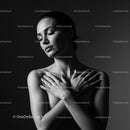 Serene woman embracing herself with closed eyes