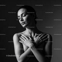 Serene woman embracing herself with closed eyes