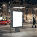Illuminated blank city billboard at night on busy street