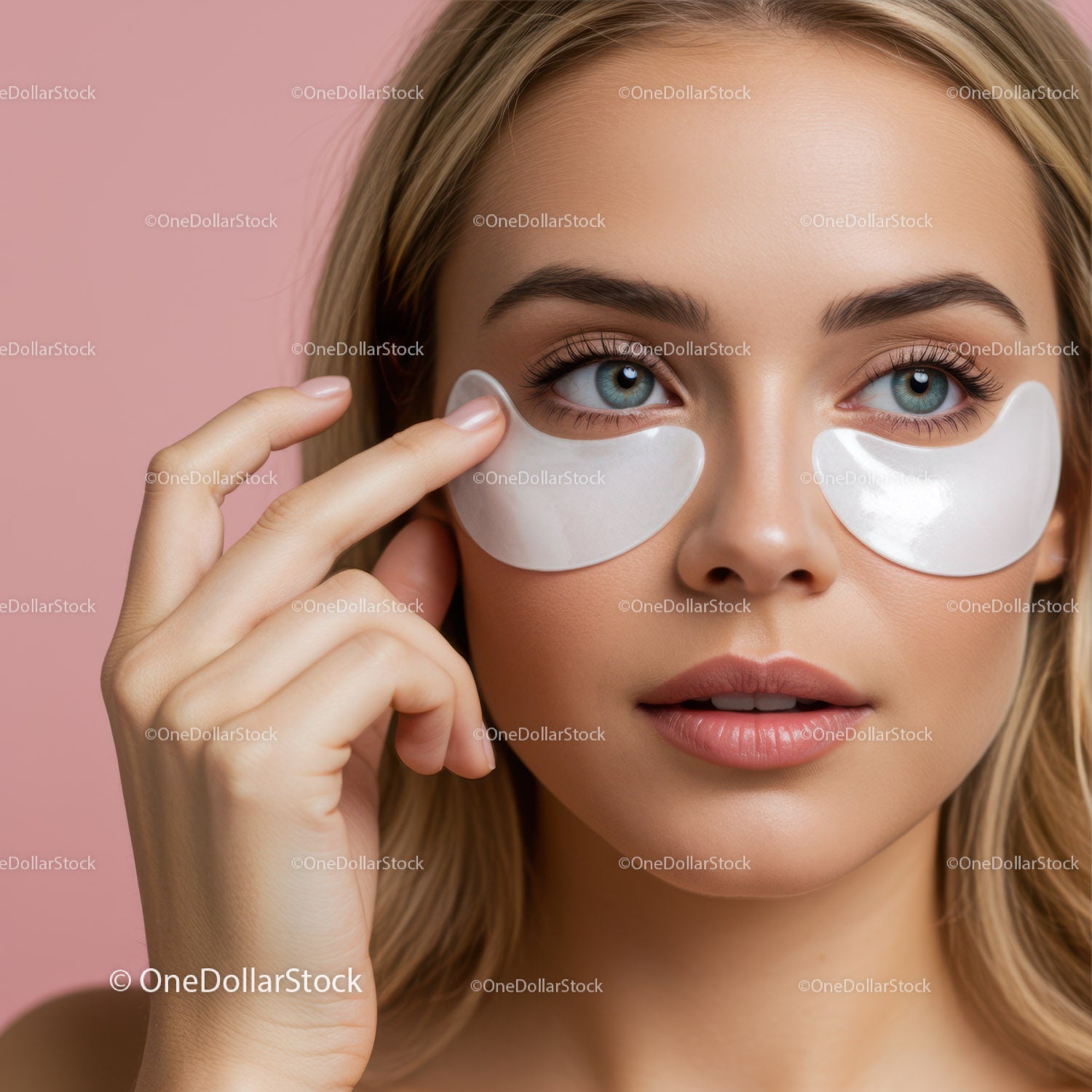 Close-up of Woman with Blue Eyes Applying Under Eye Patches for Skin Care